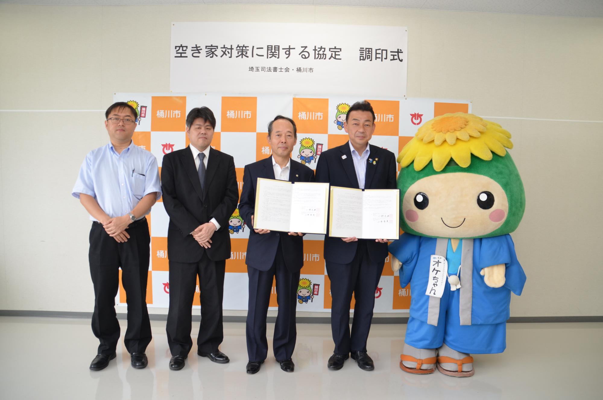 空き家対策に関する協定」締結式の集合写真。左から埼玉司法書士会の3人の方々、小野桶川市長、オケちゃん。