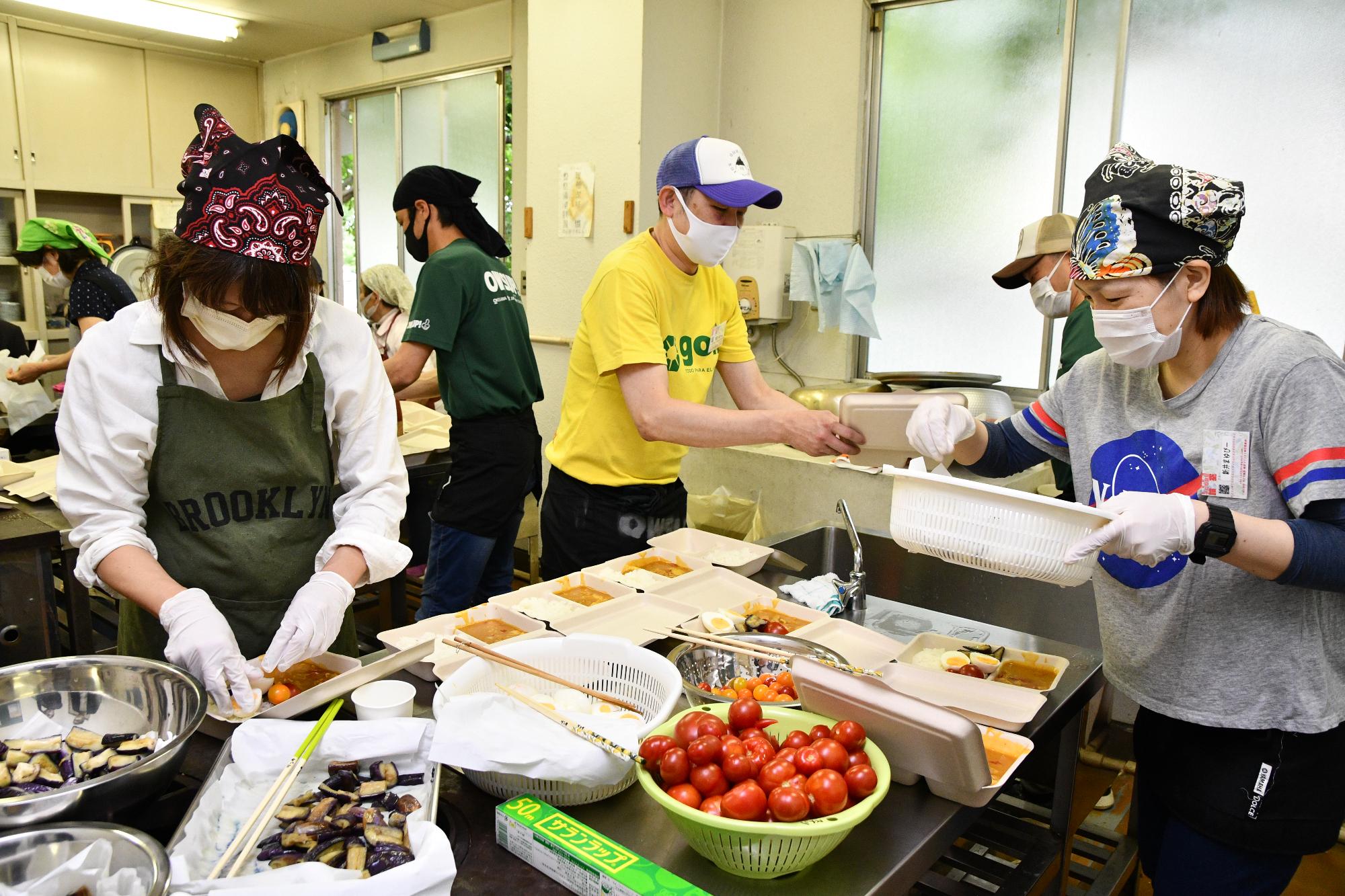 川田谷農業センター内にある調理室で、桶川西中学校のおやじの会のメンバーが中心となり、大量の夏野菜カレーを作っている様子。